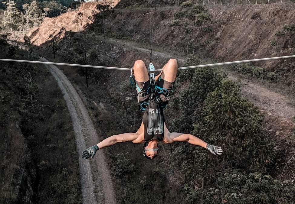 man in black tank top hanging on a rope