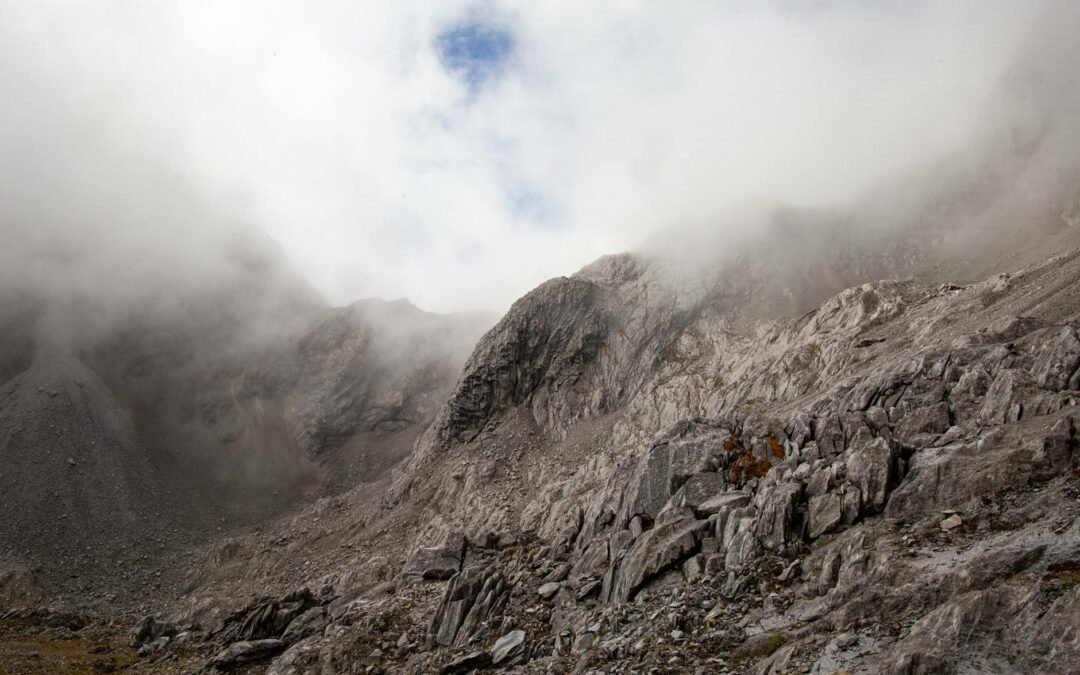 rocky mountain slope under clouds