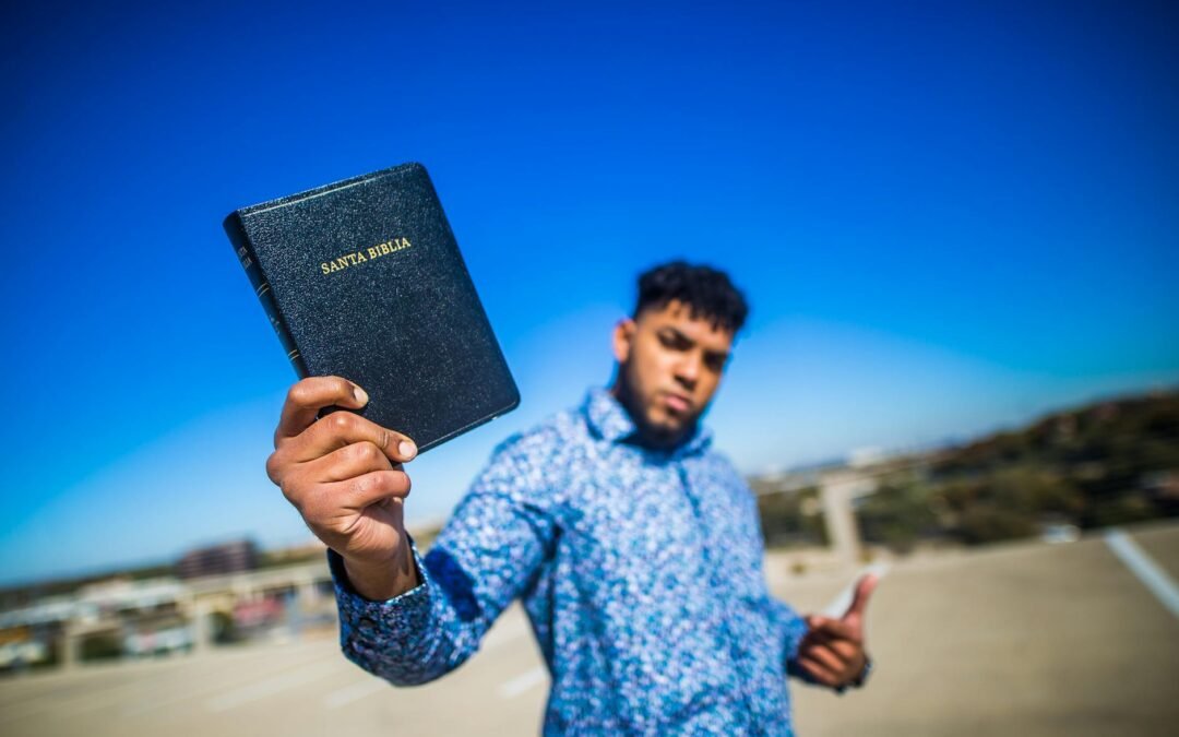 selective focus photography of man holding book