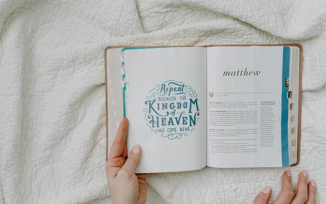 a person reading a book on the white textile