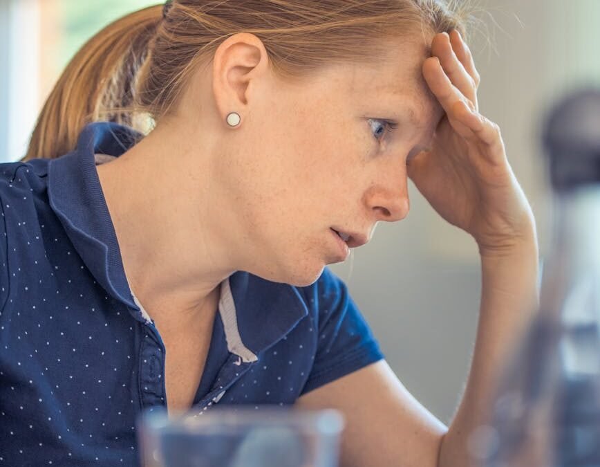 woman sitting in front of the laptop computer in shallow photo
