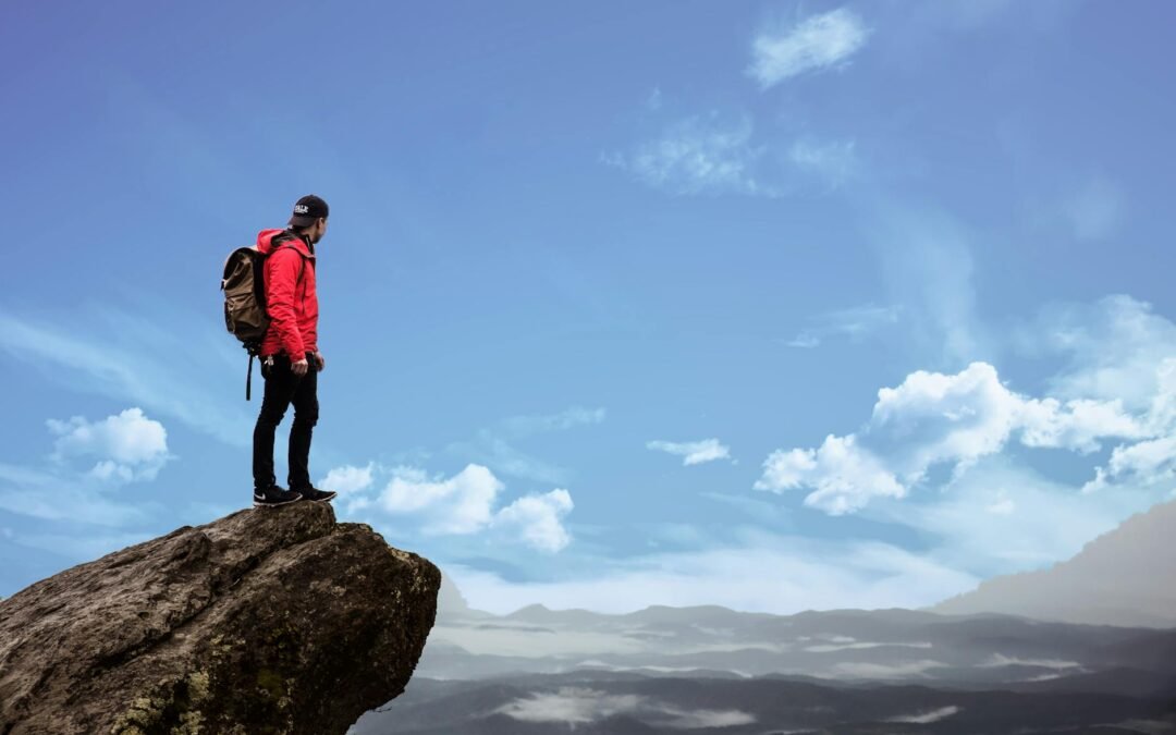 man standing on cliff photography