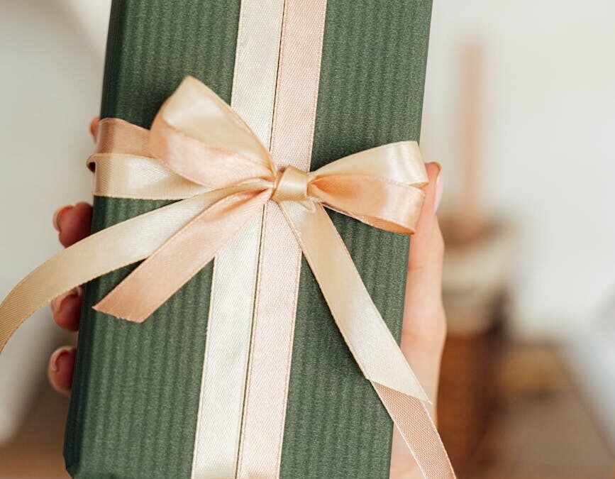 green gift box with peach ribbon