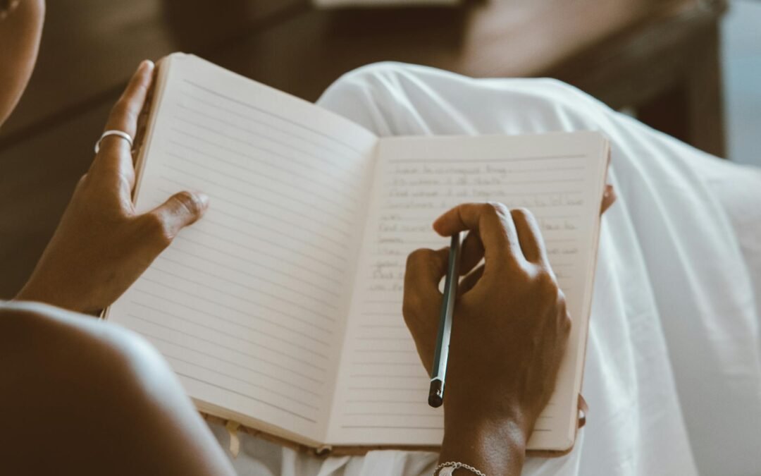 a person writing on a notebook