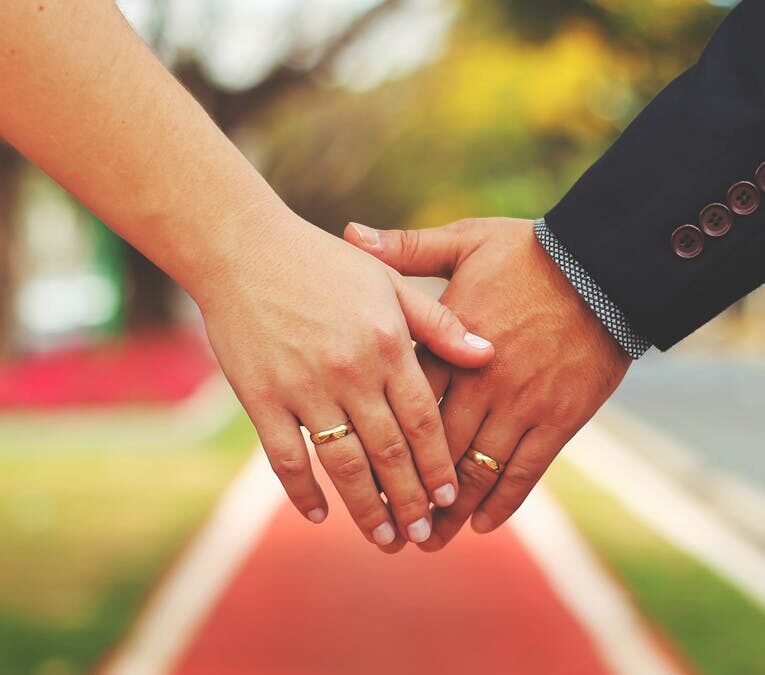 bride and groom holding hands