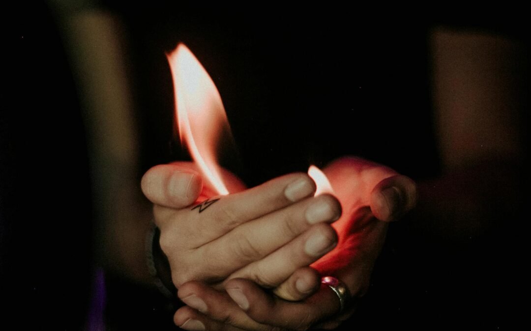 close up of fire burning in hands