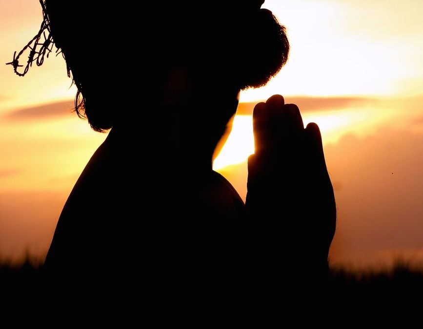 silhouette image of person praying