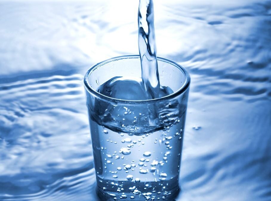 pouring water to glass on water