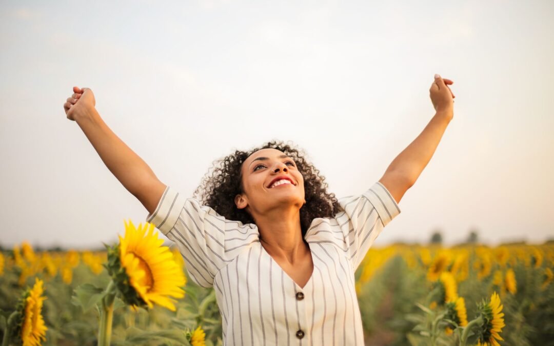 photo of woman standing on sunflower field