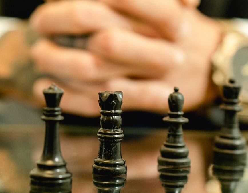 photograph of black chess pieces