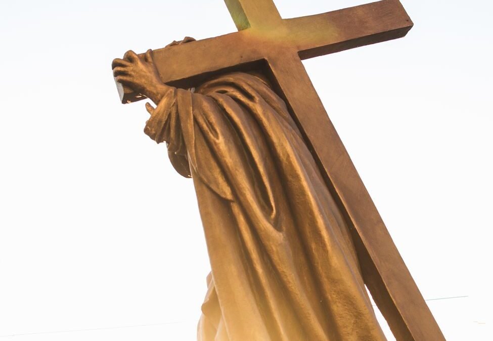 a statue of a person carrying a cross