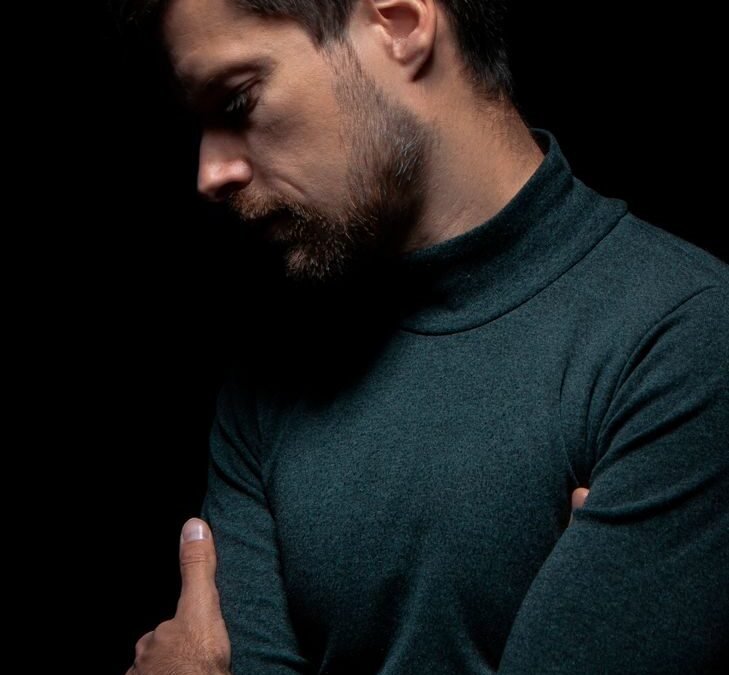 concerned man in green turtleneck