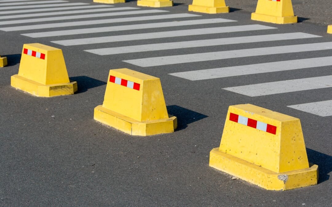 yellow barriers at road zebra crossing