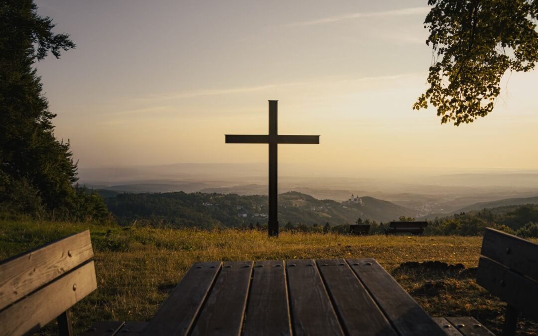 sunset view of cross on austrian hilltop