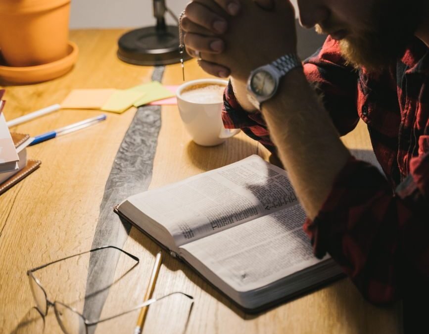 a bearded man praying