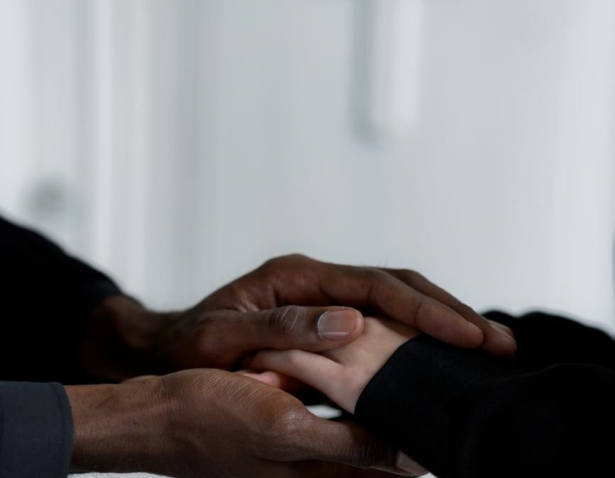 close up shot of two people holding hands