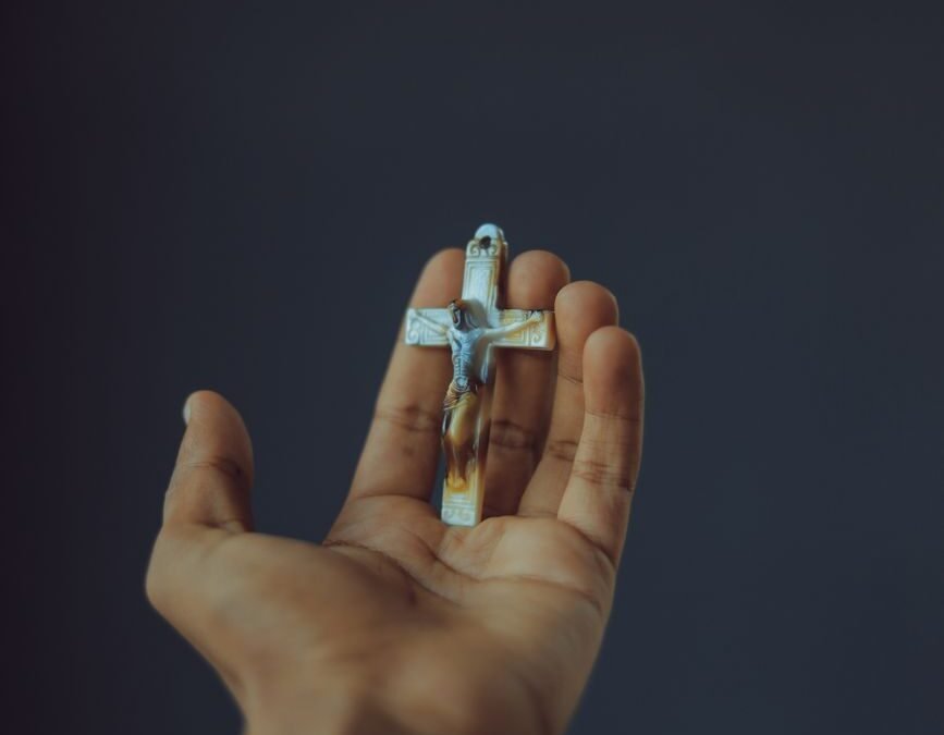 person holding a crucifix